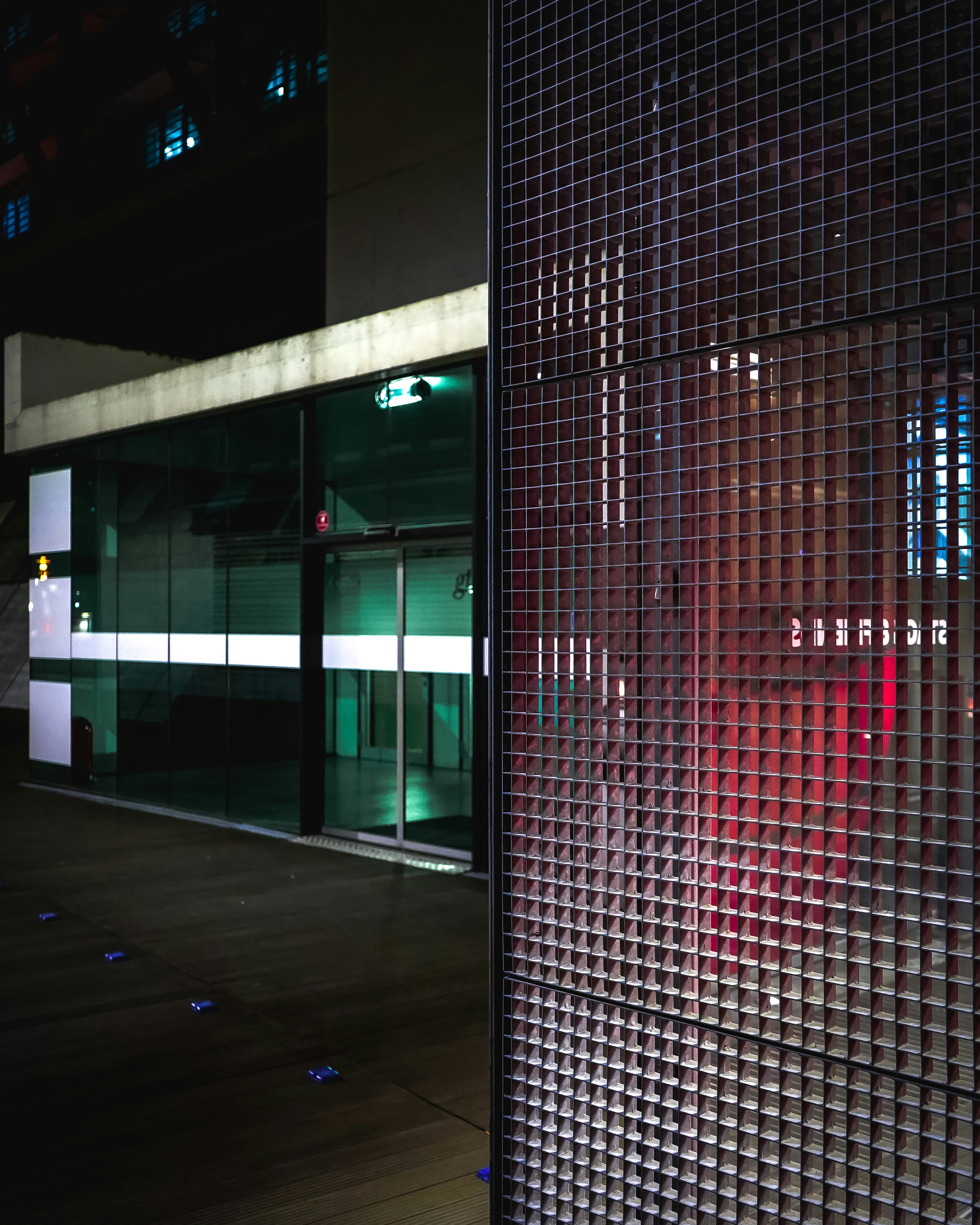 red metal mesh gate during daytime